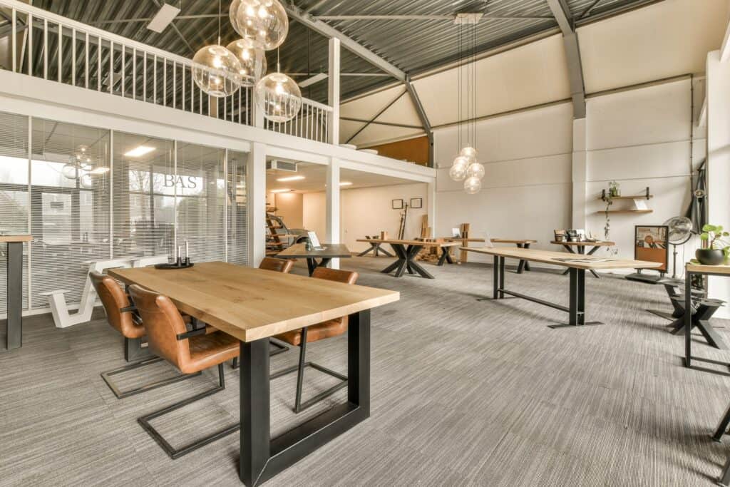 Large office tables and chairs in a huge office space before the move